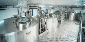 Inside the New Harbour production facility, featuring equipment with the Dildo Brewing Co. logo prominently displayed.