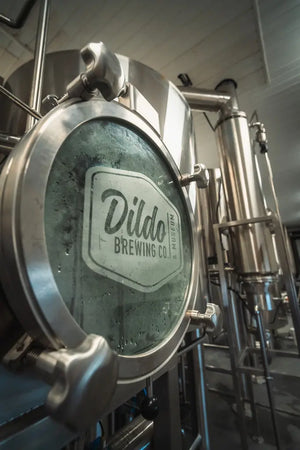 Inside the New Harbour production facility, featuring equipment with the Dildo Brewing Co. logo prominently displayed.