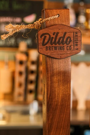 Wooden beer tap featuring the Dildo Brewing Co. logo