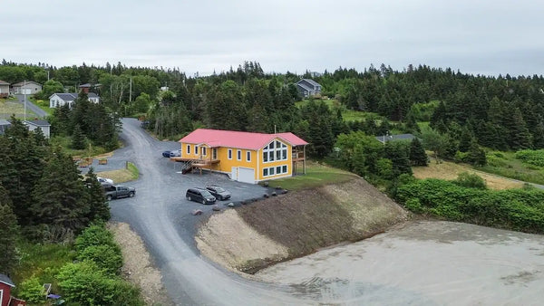 Drone view of Dildo Coffee House in Dildo, Newfoundland, showcasing its location and surroundings.