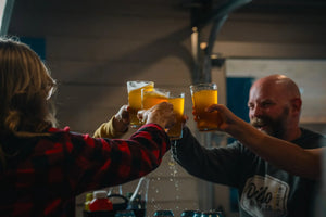 People enjoying craft beers at the Dildo Brewing Co. Taproom in Dildo, NL, with a cozy, inviting atmosphere