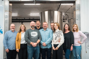 Dildo Brewing Co. team posing together, showcasing the people behind the craft beer.